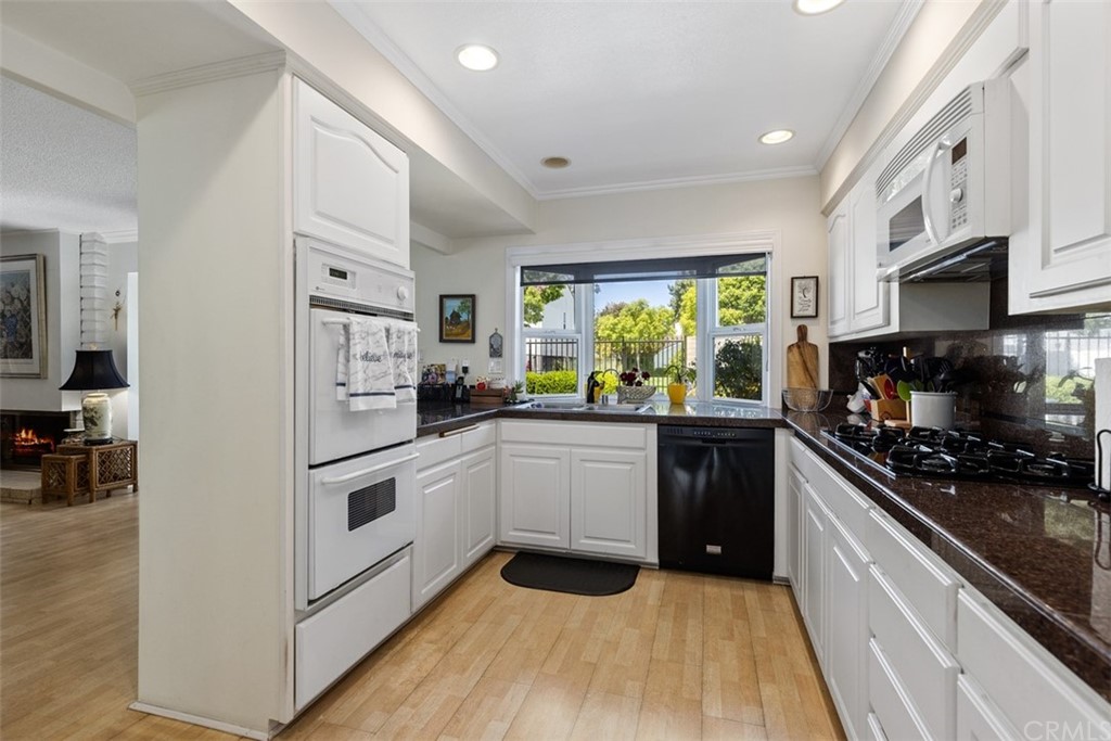 10 Mandrake Way Irvine, CA 92612 - Photo 11 of 35 a kitchen with stainless steel appliances granite countertop a stove a sink and a refrigerator