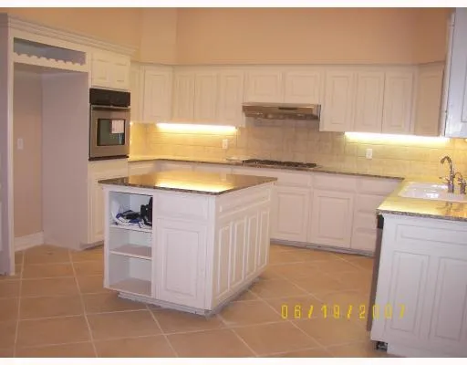 a kitchen with stainless steel appliances a sink stove and cabinets