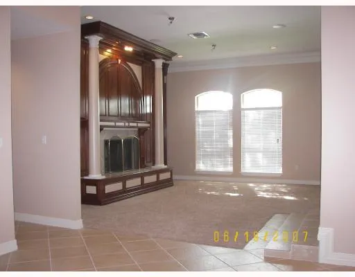 a living room with furniture and floor to ceiling windows