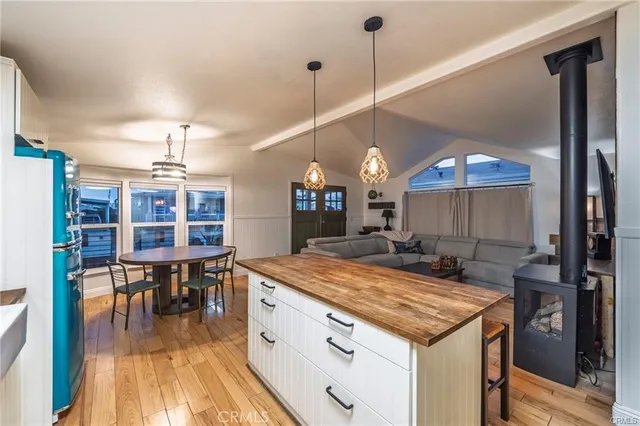 a kitchen with stainless steel appliances granite countertop a sink a stove and a wooden floors