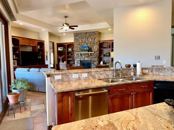 a kitchen with stainless steel appliances kitchen island granite countertop a sink and cabinets