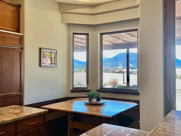 a view of a workspace with furniture and window