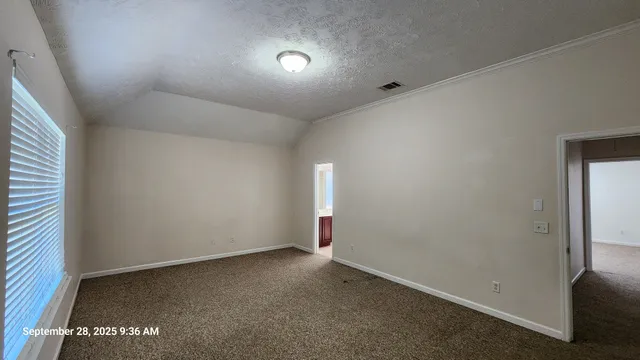 an empty room with an entryway and closet