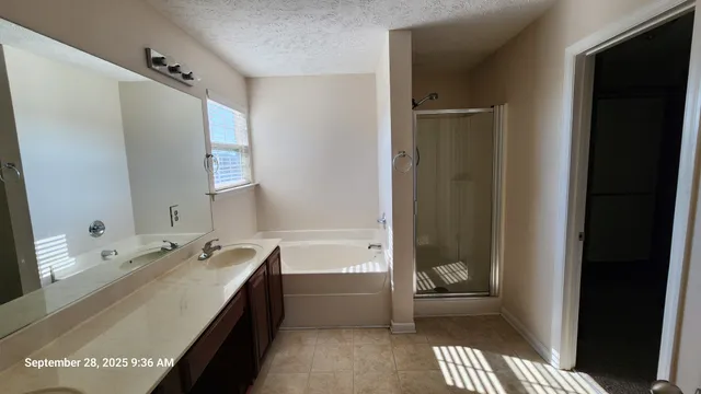 a bathroom with a tub sink and a mirror