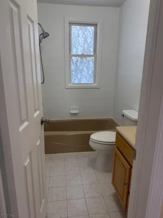 a white toilet sitting next to a bathroom sink
