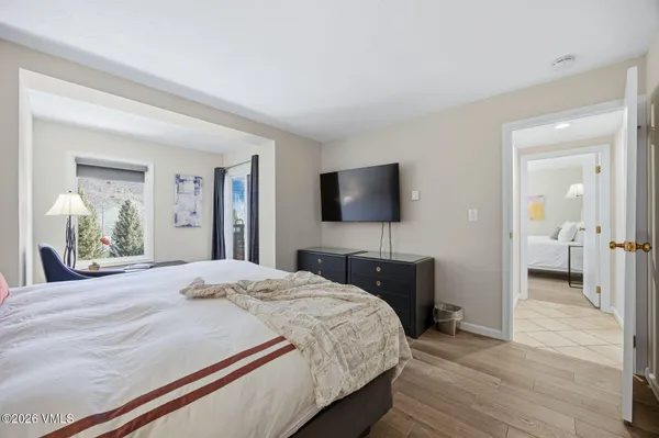 a bedroom with a bed and a flat screen tv