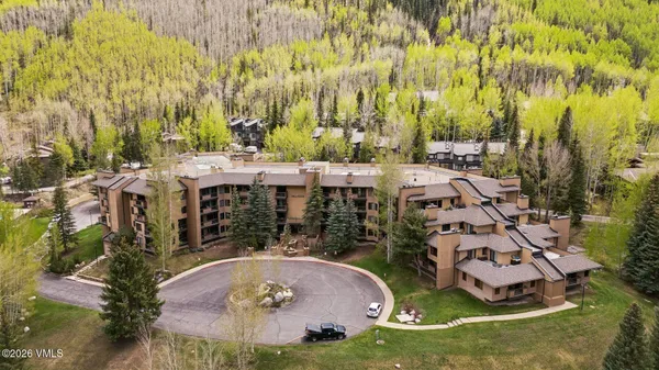 an aerial view of a house with garden space and trees
