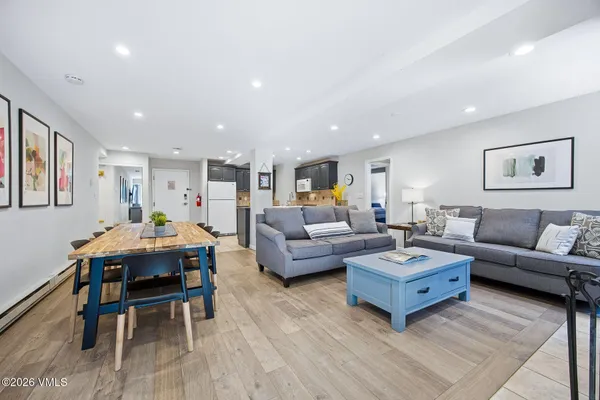 a living room with furniture and a wooden floor