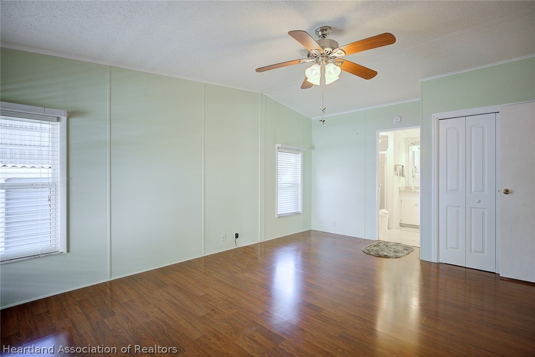 2702 Rodney Street Sebring, FL 33872 - Photo 18 of 33 an empty room with wooden floor and windows