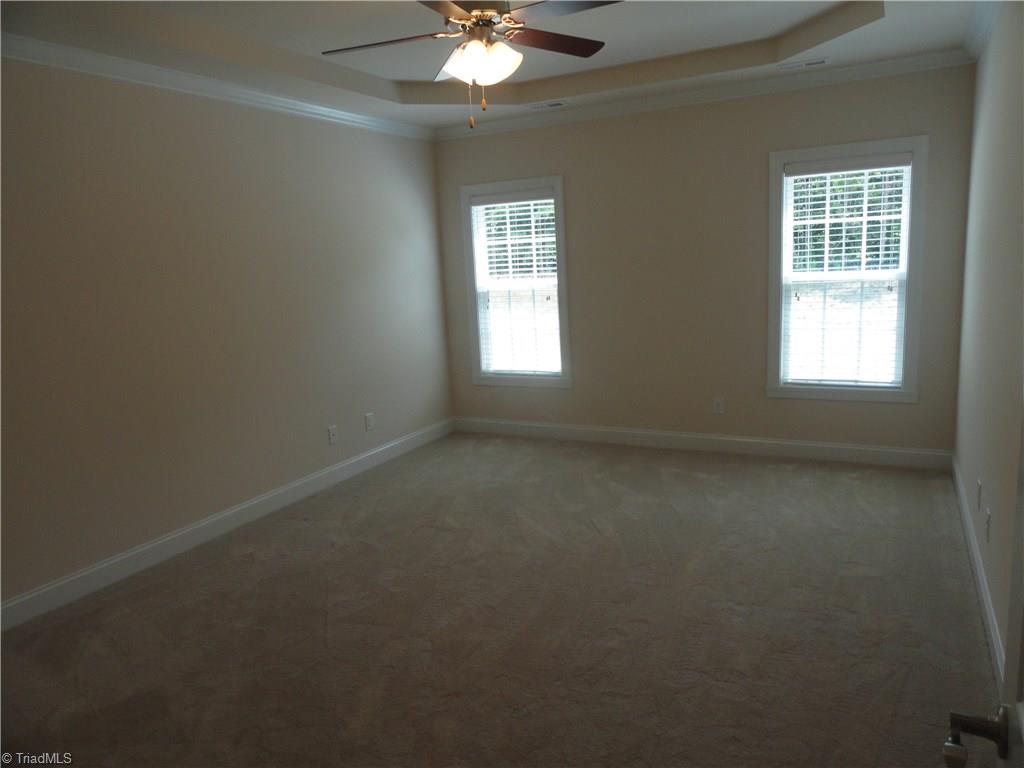 2814 Fallin Court High Point, NC 27262 - Photo 12 of 16 Master bedroom with tray ceiling and fan