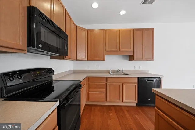 a kitchen with stainless steel appliances a refrigerator and a stove top oven