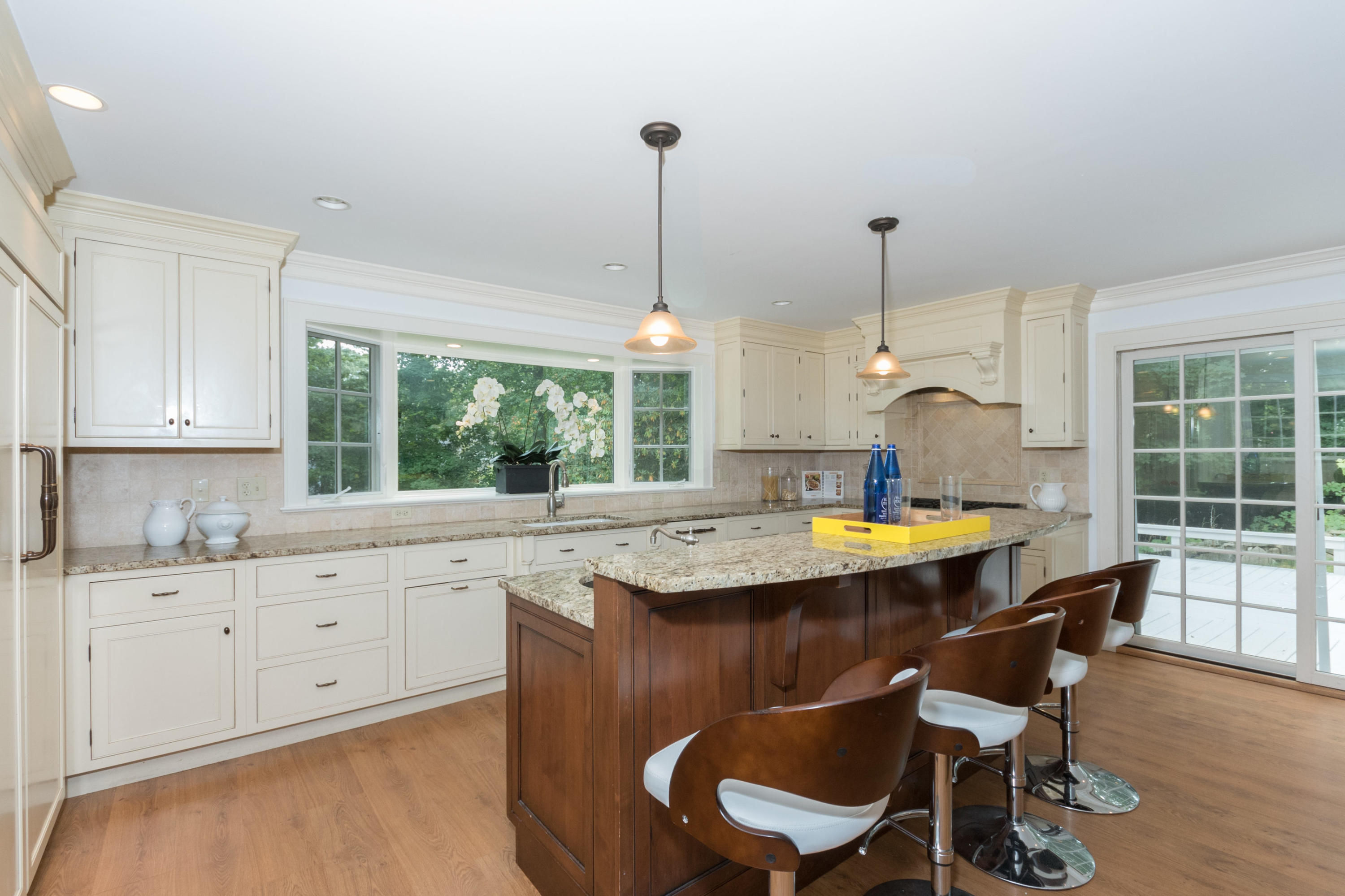 55 Cedar Gate Road Darien, CT 06820 - Photo 7 of 41 a kitchen with a dining table chairs and white cabinets