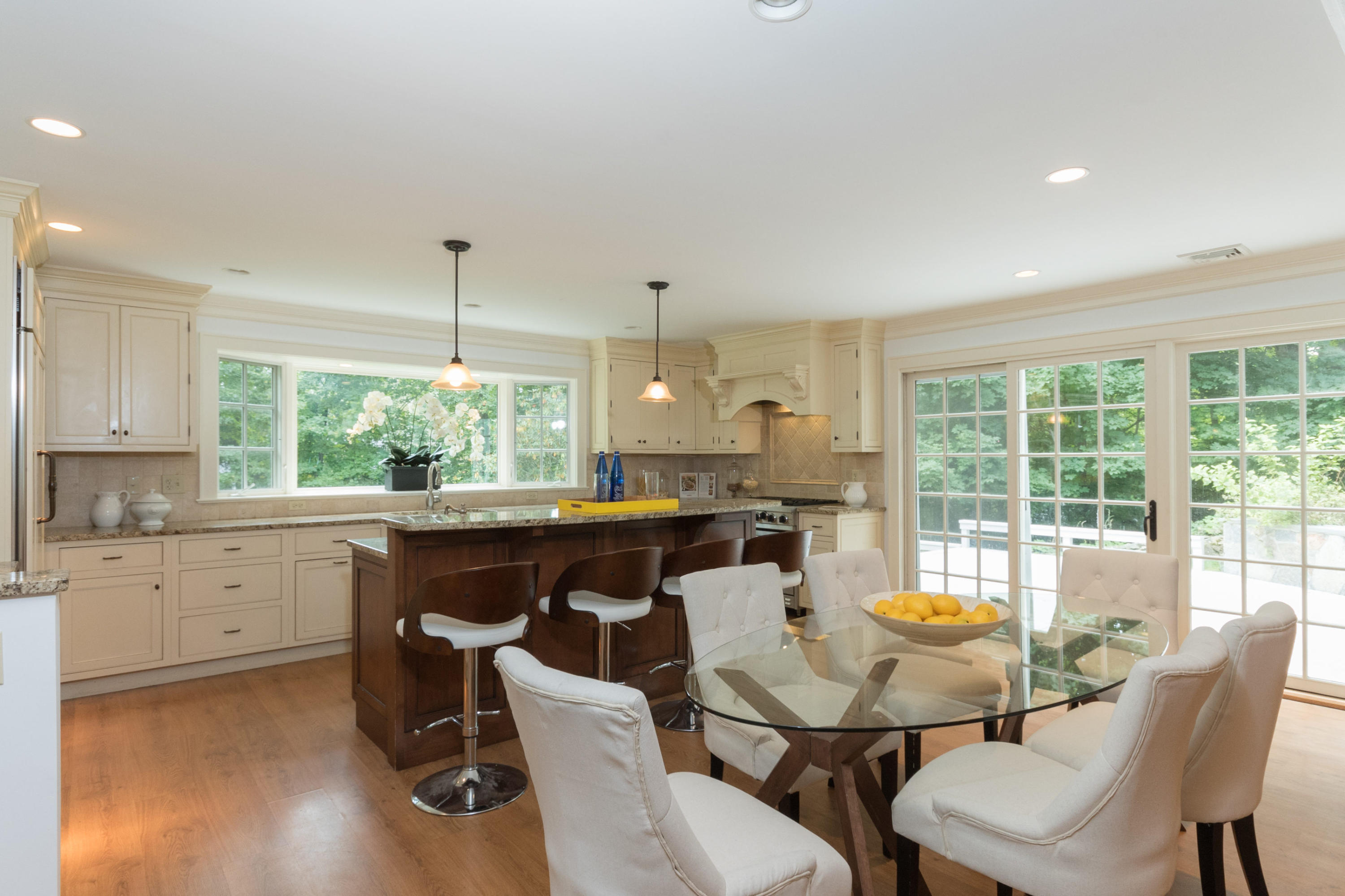 55 Cedar Gate Road Darien, CT 06820 - Photo 8 of 41 a view of a dining room and kitchen with a table chairs a workspace