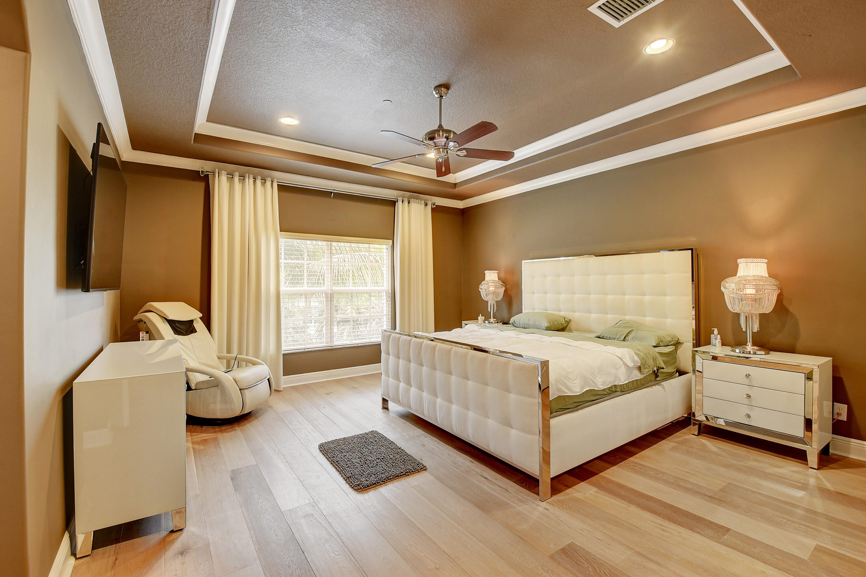 5645 Northeast Trieste Way Boca Raton, FL 33487 - Photo 19 of 38 a bedroom with a bed and a window