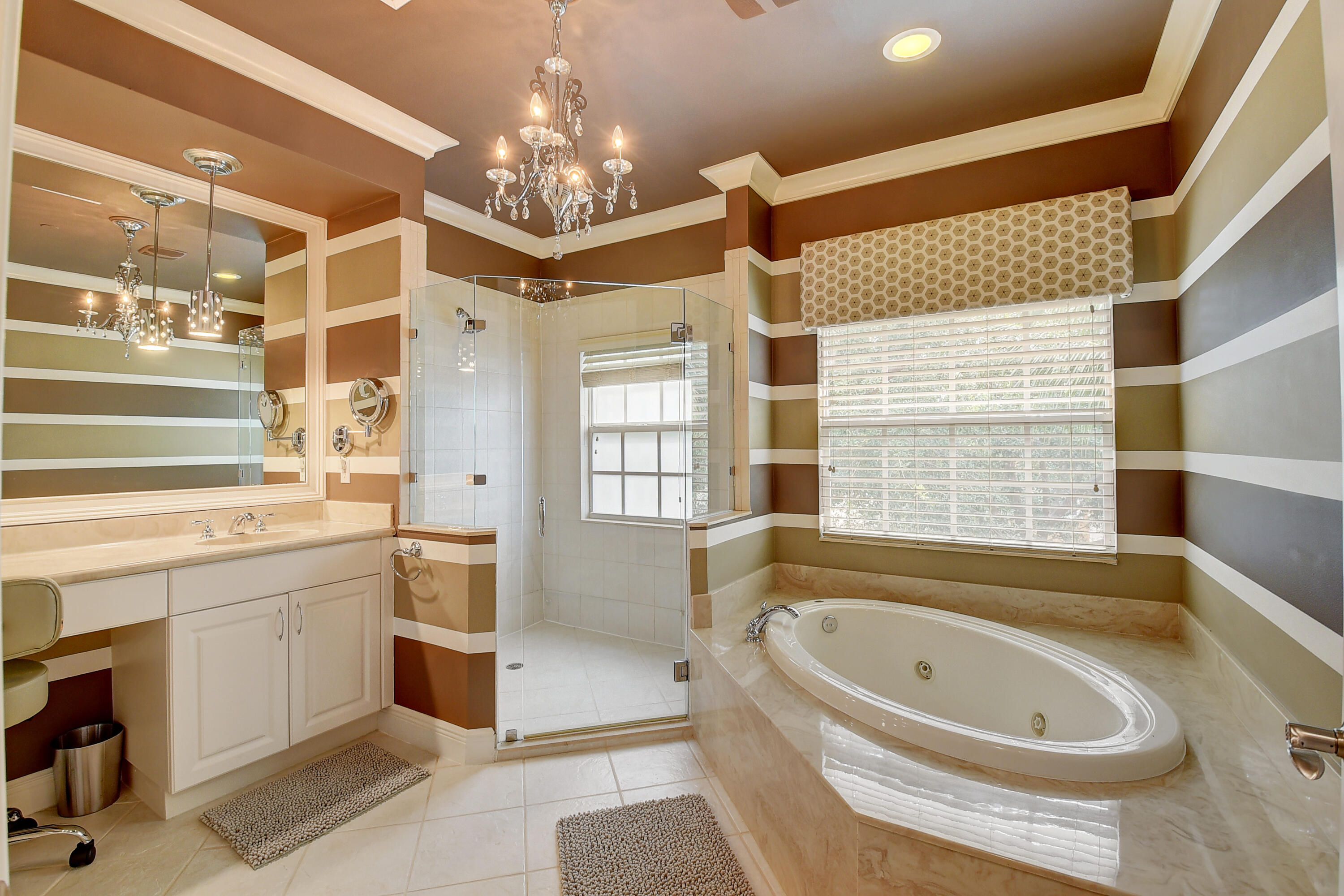5645 Northeast Trieste Way Boca Raton, FL 33487 - Photo 21 of 38 a bathroom with a bathtub a sink and a large window
