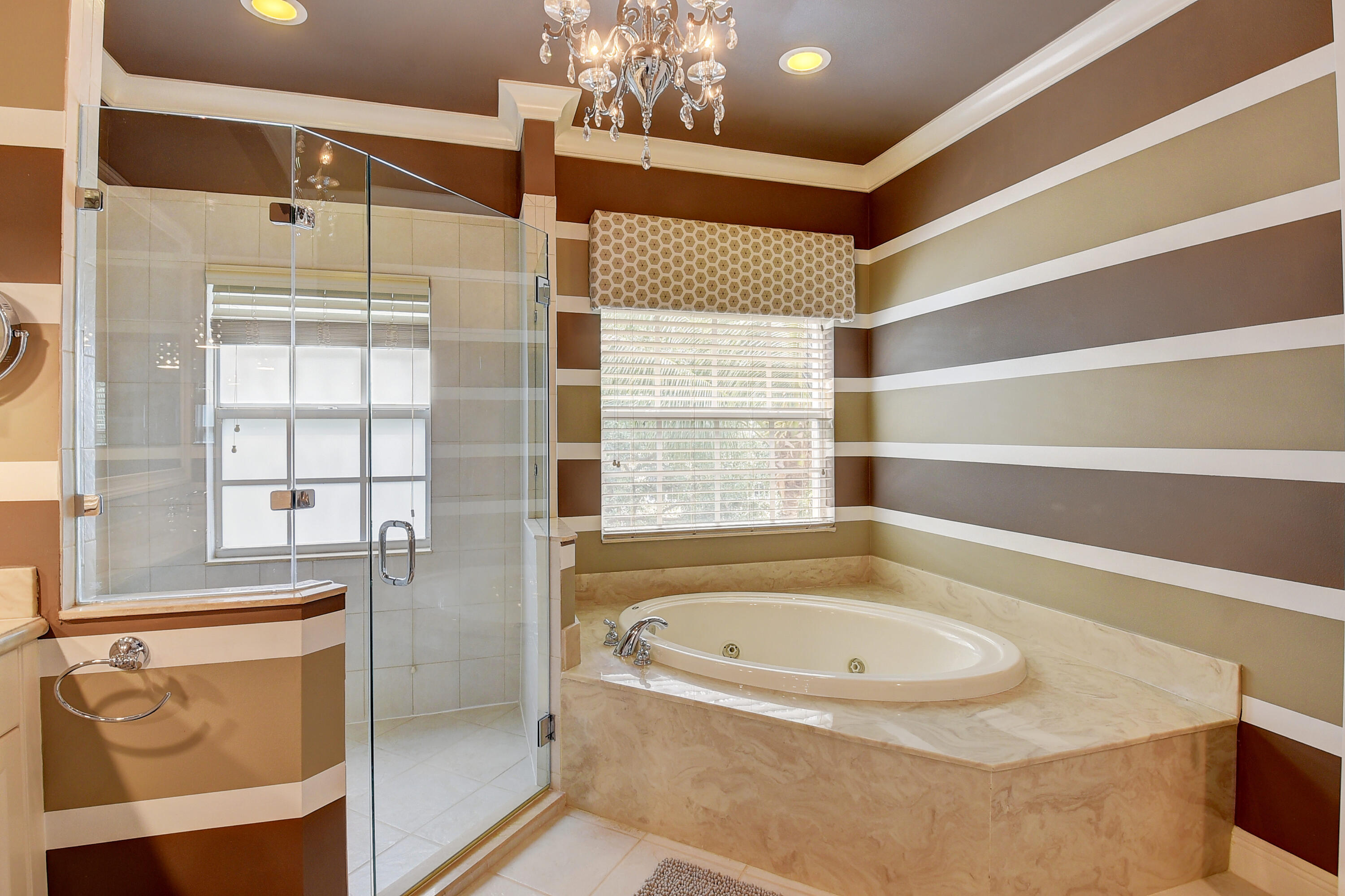 5645 Northeast Trieste Way Boca Raton, FL 33487 - Photo 22 of 38 a bathroom with a tub and a window