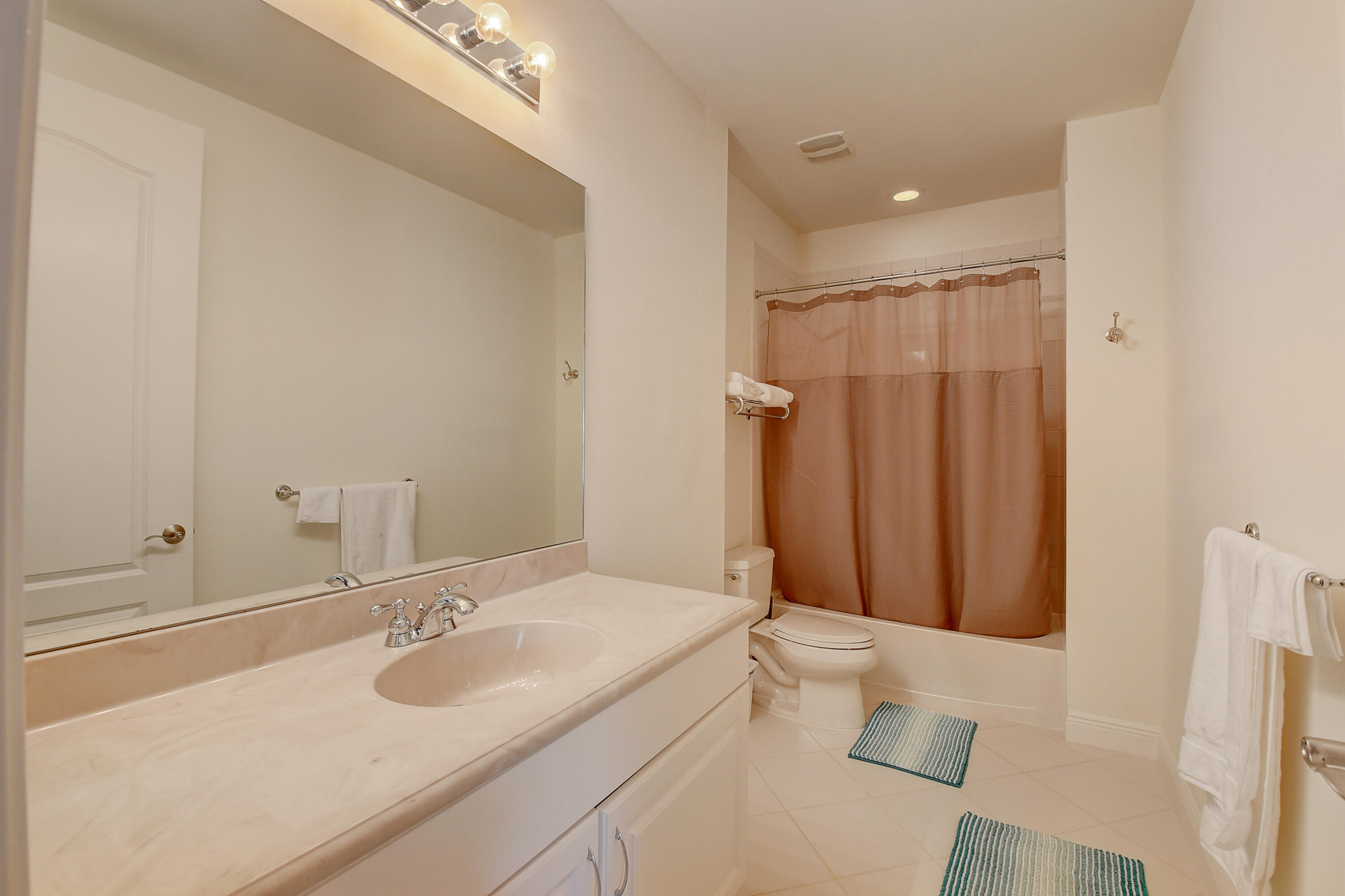 5645 Northeast Trieste Way Boca Raton, FL 33487 - Photo 25 of 38 a bathroom with a sink toilet and shower