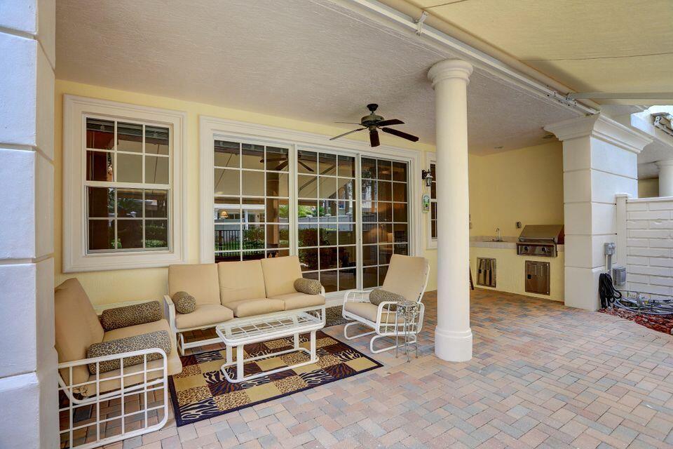 5645 Northeast Trieste Way Boca Raton, FL 33487 - Photo 29 of 38 a balcony with table and chairs
