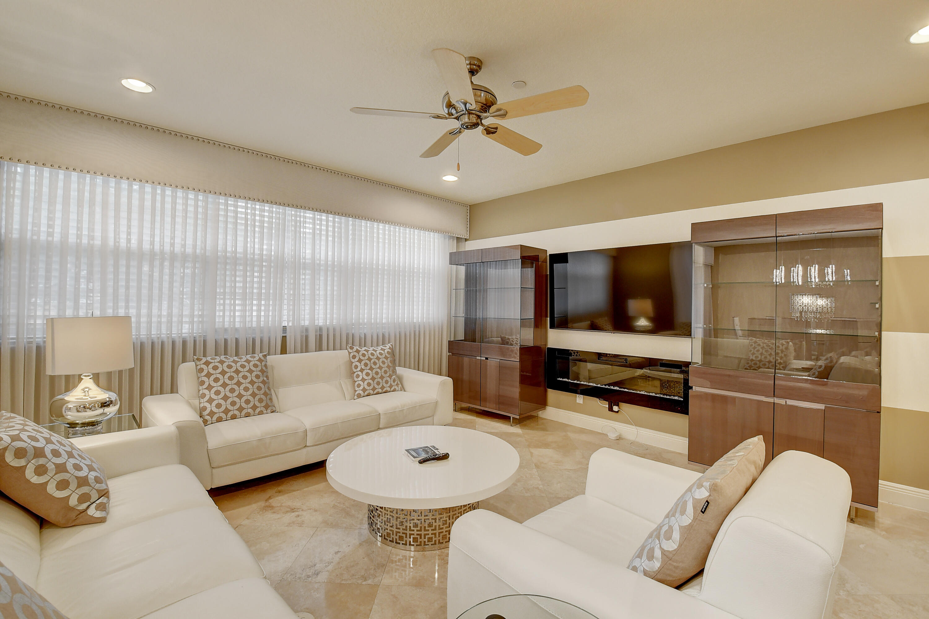 5645 Northeast Trieste Way Boca Raton, FL 33487 - Photo 7 of 38 a living room with furniture and a flat screen tv