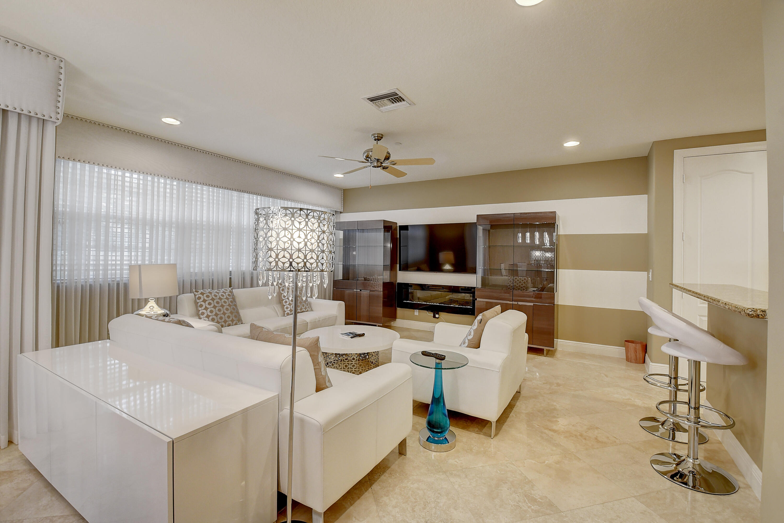 5645 Northeast Trieste Way Boca Raton, FL 33487 - Photo 9 of 38 a living room with furniture and a flat screen tv