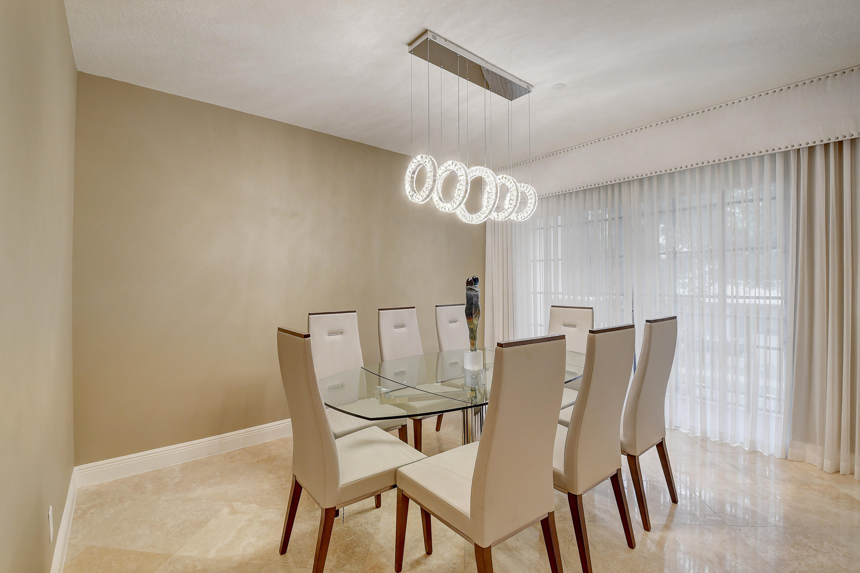 5645 Northeast Trieste Way Boca Raton, FL 33487 - Photo 10 of 38 a view of a dining room with furniture and chandelier