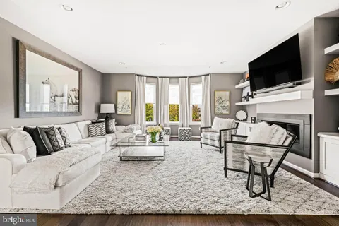 a living room with furniture a rug and a table