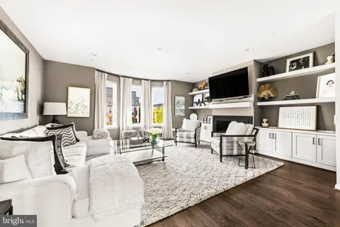 a large white kitchen with stainless steel appliances kitchen island granite countertop a stove and white cabinets