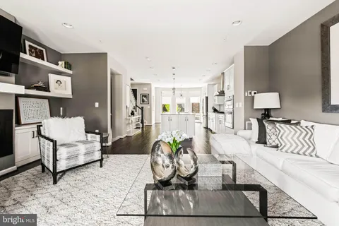 a open kitchen with stainless steel appliances granite countertop a lot of counter space and wooden floors