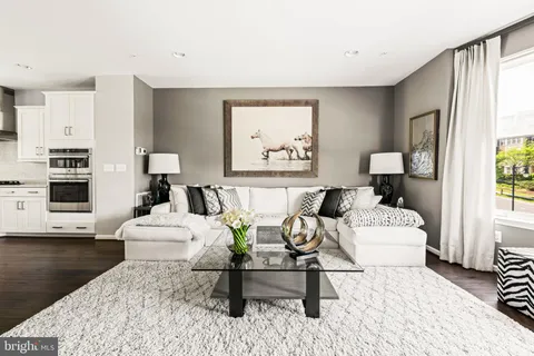 a dining room with furniture a rug and a floor to ceiling window