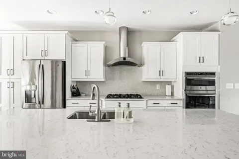 a bedroom with a large bed and a large window