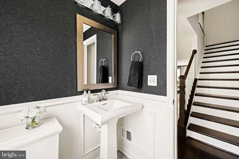 a view of a workspace with furniture and a flat screen tv