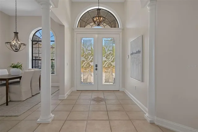 a bedroom with a bed and a chandelier
