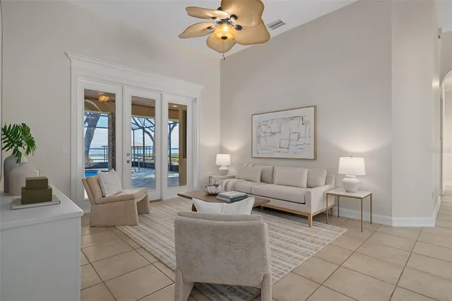 a bedroom with a large bed and ceiling fan