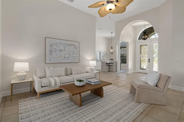 a bedroom with a large bed and a chandelier