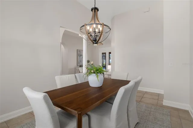 a spacious bedroom with a bed and glass doors