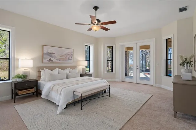 a bedroom with a large bed and a chandelier