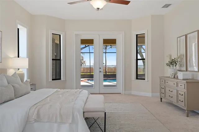 a kitchen with white cabinets and chandelier