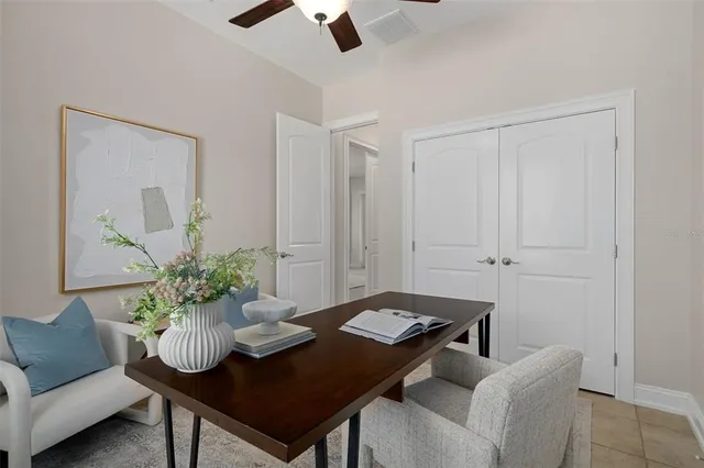 an empty room with closet and a ceiling fan