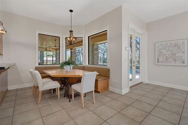 a view of a backyard with plants and large trees