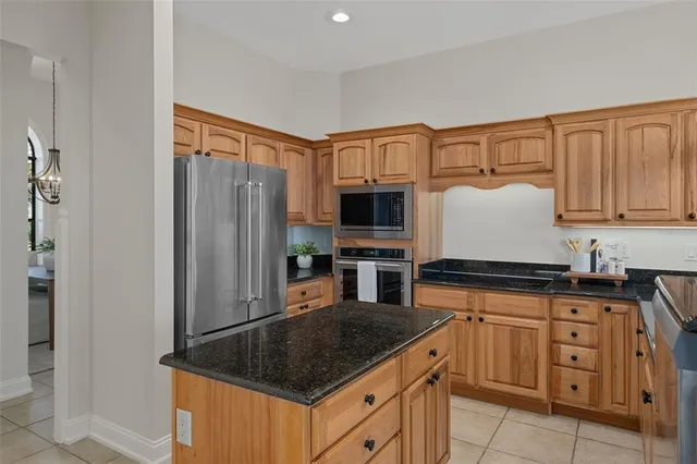 a view of a yard with plants and large trees