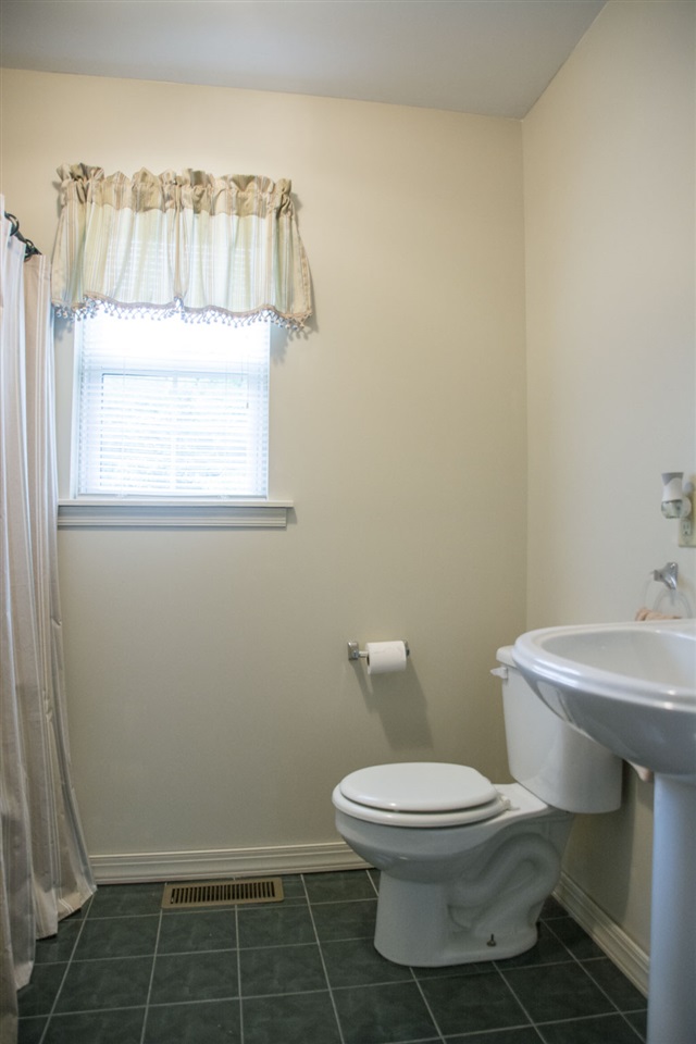 1380 New Hope Road Staunton, VA 24401 - Photo 18 of 28 a white toilet sitting next to a bathroom sink