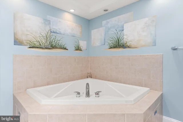 a kitchen with kitchen island granite countertop a sink and refrigerator