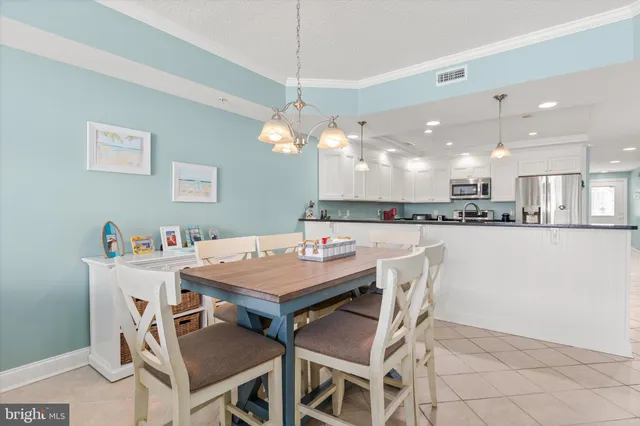 a large kitchen with stainless steel appliances granite countertop a sink and white cabinets