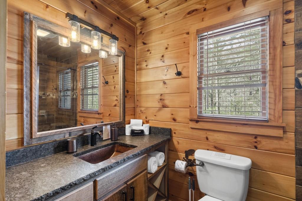 77 Old Covered Bridge Road Cherry Log, GA 30522 - Photo 19 of 40 a bathroom with a granite countertop toilet a sink and a bathtub