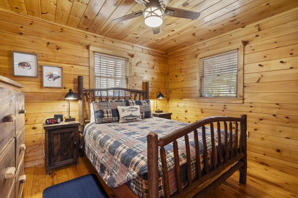 77 Old Covered Bridge Road Cherry Log, GA 30522 - Photo 20 of 40 a bedroom with a bed and a table in it