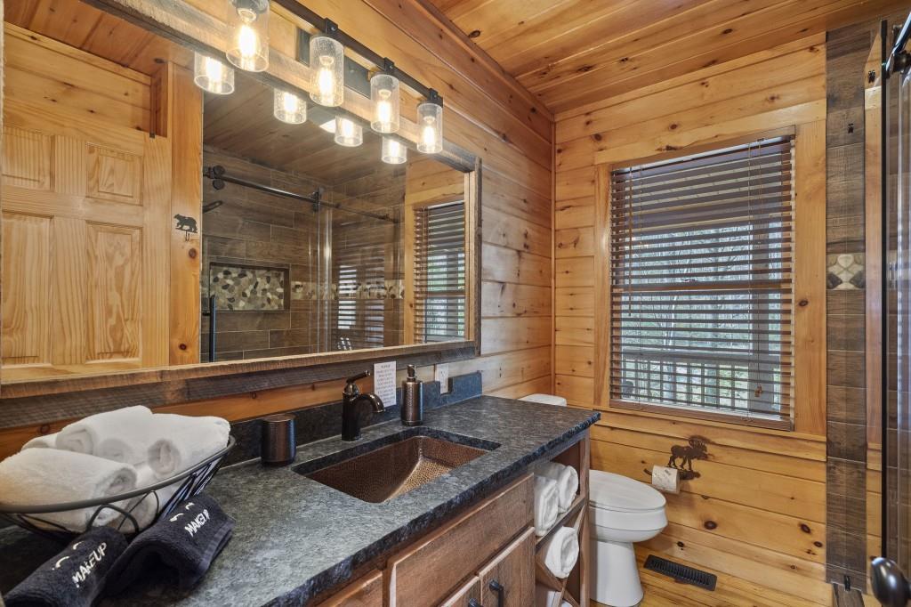 77 Old Covered Bridge Road Cherry Log, GA 30522 - Photo 21 of 40 a bathroom with a granite countertop sink and a mirror