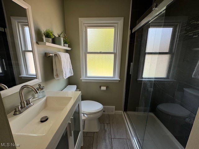 30101 Oakdale Road Willowick, OH 44095 - Photo 8 of 17 Full bathroom with toilet, a shower stall, vanity, and baseboards