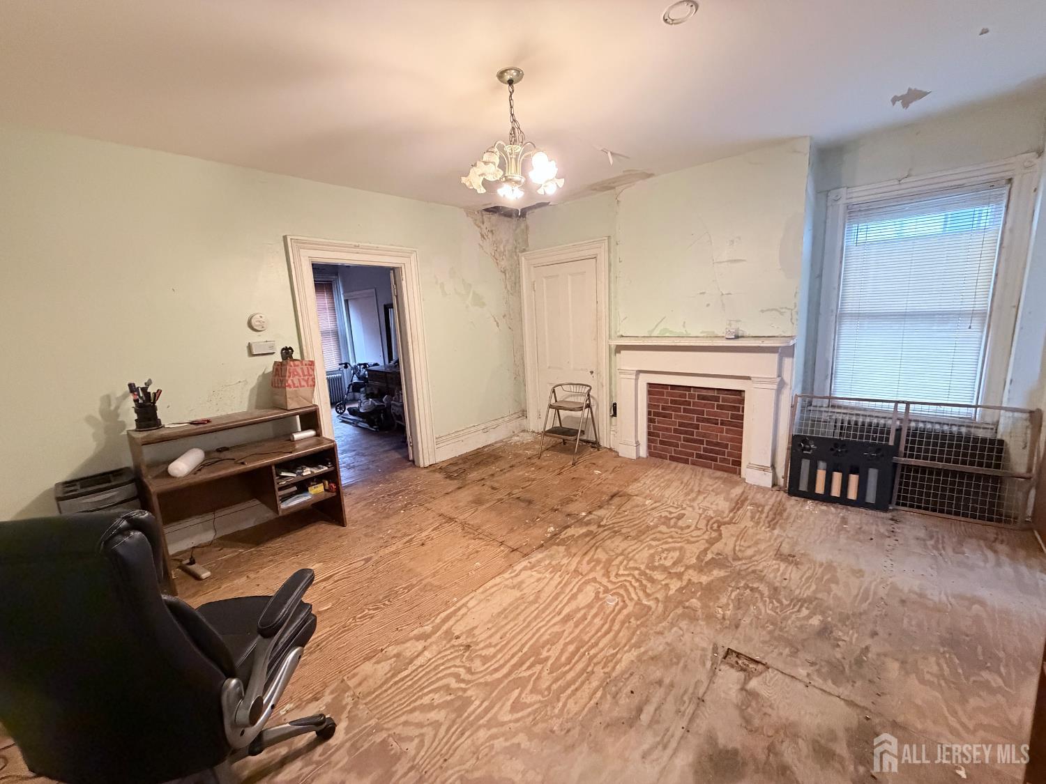 41 Atlantic Street Keyport, NJ 07735 - Photo 21 of 48 a living room with furniture a fireplace and a chandelier
