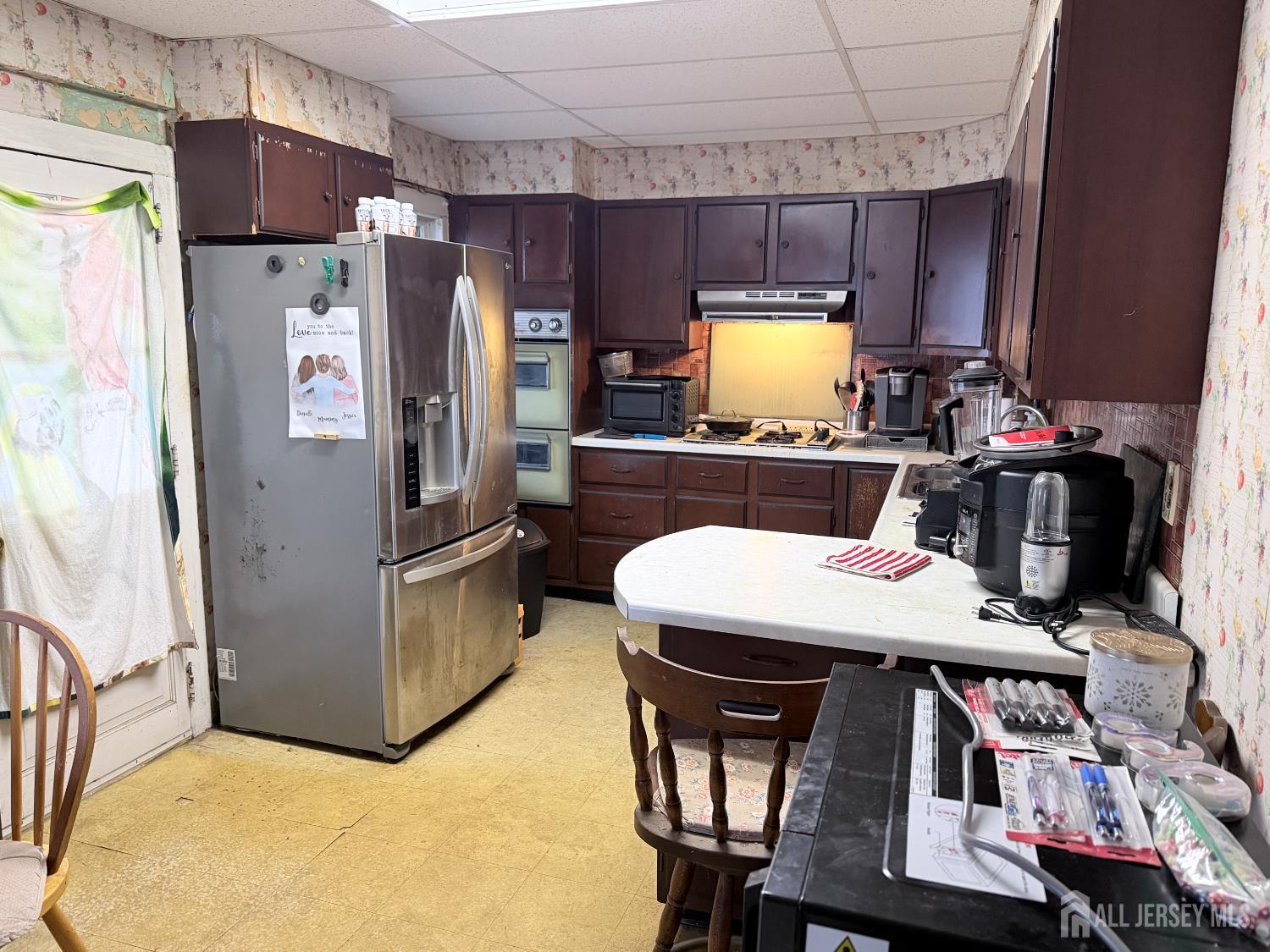41 Atlantic Street Keyport, NJ 07735 - Photo 25 of 48 a kitchen with refrigerator and chairs
