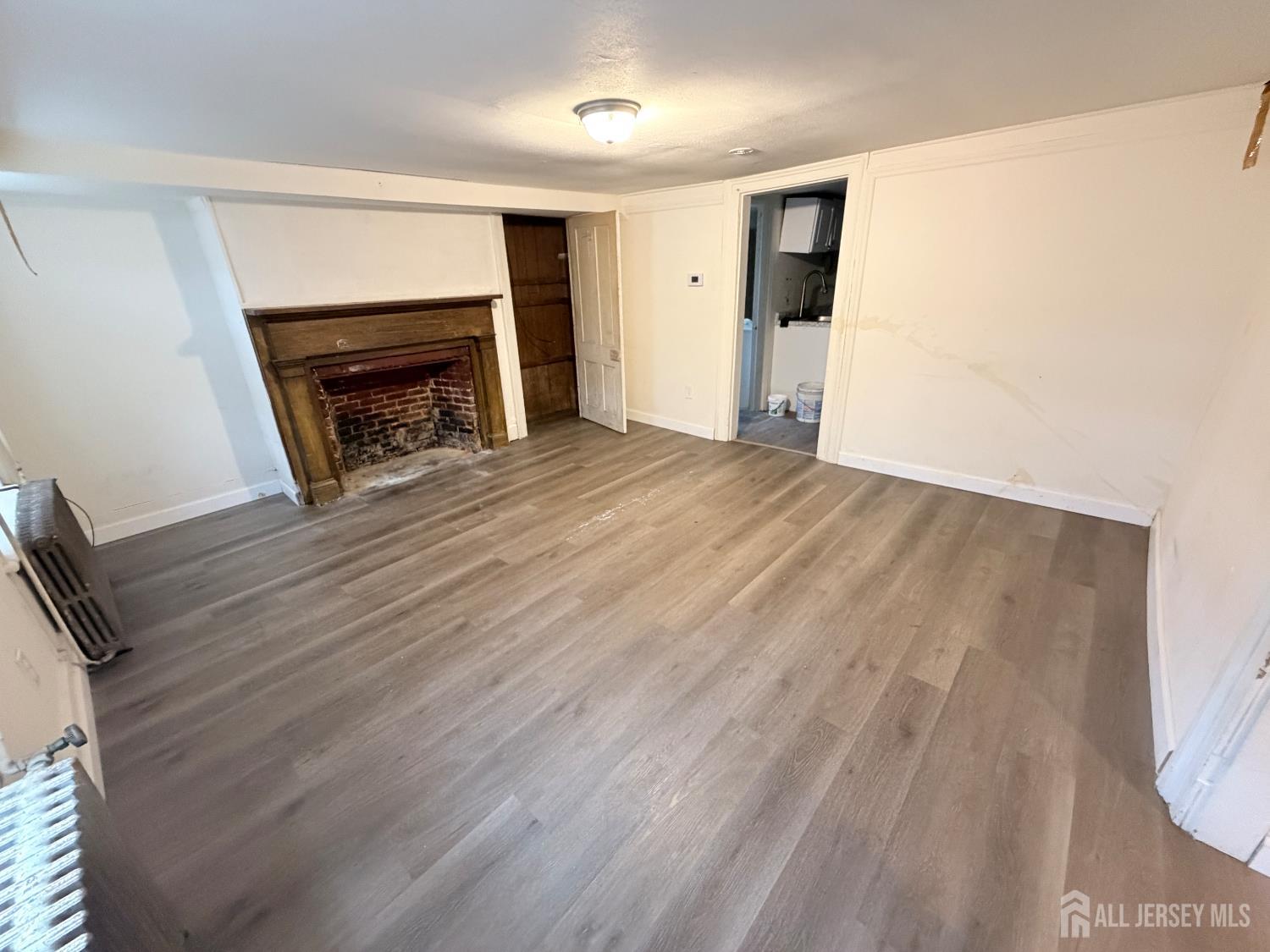 41 Atlantic Street Keyport, NJ 07735 - Photo 28 of 48 a view of empty room with wooden floor and fireplace